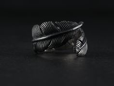 The Raven Feather Ring by Lost Apostle Luxe. Hand carved and cast in Sterling silver, with an oxidized finish and burnished details at the tip of the feather and at the quill.  The ring is extremely comfortable to wear with a high polish finish on the inside of the band.  Please indicate your size from the menu - the ring by design can be adjusted to ensure a perfect fit. Oc Details, Raven Ring For Men, Raven Rings, Silver Feather Jewelry, Crow Ring, Weding Rings, Elegant Black Feather Jewelry, Beard Rings, Raven Ring