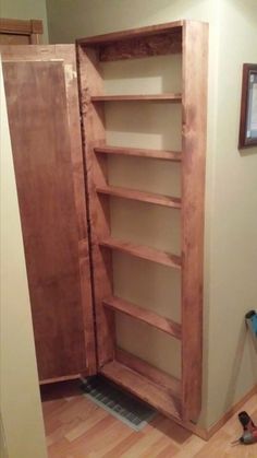 an unfinished bookcase in the corner of a room