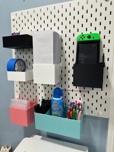 a white toilet sitting next to a wall mounted shelf