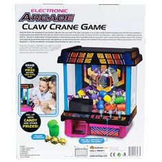 the electronic arcade claw crane game is in its box with instructions on how to play