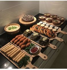 a table topped with lots of different types of foods and desserts on trays