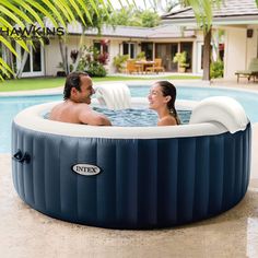 a man and woman sitting in an intex hot tub next to a swimming pool