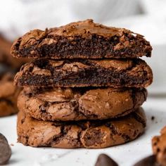 three chocolate cookies stacked on top of each other, with one cookie in the middle