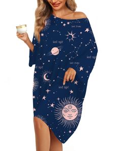 a woman in a blue dress with stars and planets on it, holding a cup