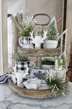 three tiered tray with coffee mugs and christmas decorations