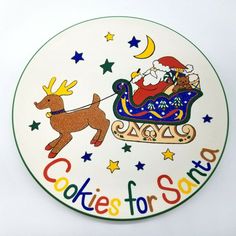 a christmas plate with santa riding a sleigh and reindeer on it's back