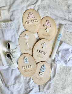 four wooden buttons with the names of each child's birth date and baby shoes