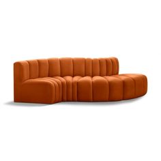 an orange couch sitting on top of a white floor