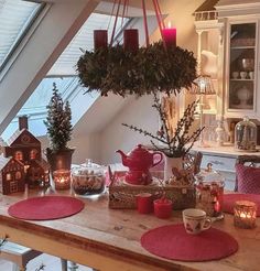 the table is set with candles, teapots and other things to decorate it