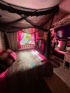 a bedroom decorated in pink, black and white with a bed covered in leopard print