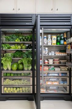 two refrigerators filled with different types of food and drinks in the middle of a kitchen