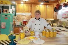 a woman in a kitchen with jars of food on the counter