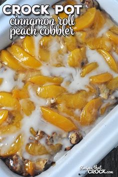 crock pot with cinnamon peach peach cobbler in white casserole dish on wooden table