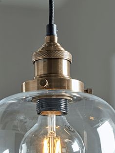 a clear glass light fixture hanging from a ceiling