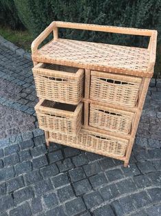 a wicker cabinet with four baskets on it