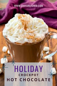 a hot chocolate drink with whipped cream in it and the words holiday crockpot hot chocolate