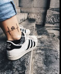 a person's foot with a small tattoo on the side of their ankle that reads, i love you