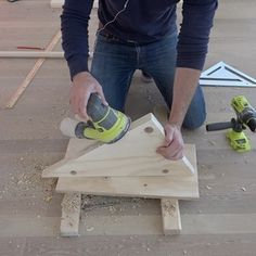 a man is sanding up some wood with a grinder and power drill in his hand