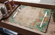 a place setting with silverware and drinks on a wooden table