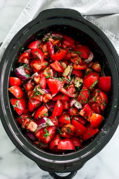 a pot filled with chopped tomatoes and onions