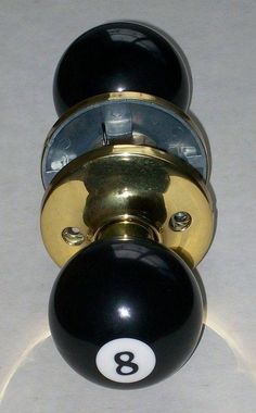 a black and gold door knob with the number eight on it