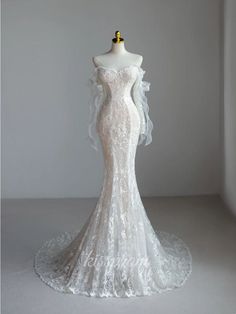 a white wedding dress on a mannequin