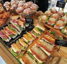 many sandwiches and croissants are on display