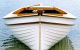 a white boat sitting on top of a body of water