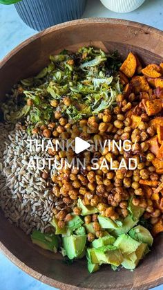 a wooden bowl filled with different types of food and words that read thank giving autumn salad