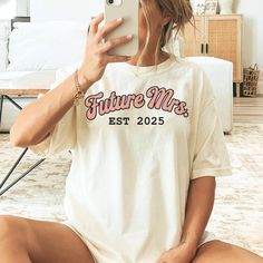 Introducing our Personalized Future Mrs. Shirt - the perfect, fun way to embrace your pre-wedding excitement with a playful twist! Featuring a bold and trendy design, this shirt is ideal for the bride-to-be who's ready to take charge and make her wedding dreams a reality (with a little sass, of course!) DETAILS: ✨ Material: Made from plush 100% ring-spun cotton for ultimate comfort. ✨ Fit: Relaxed charm that effortlessly blends style and ease. ✨ Softness: Enchantingly soft-washed fabric for daily bliss. 📍SIZING📍 ✨ Unisex Universe: The sizing isn't just unisex; it's a versatile canvas for everyone. 🚚Shipping: Ships from USA ~ Tracking Included Please allow 1-5 business days to prepare and post your order!🙂 ❗As each item is made to order, we are unable to accept returns or exchanges for Future Mrs Shirt, Bachelorette Shirt, Mrs Shirt, Bride Shirt, Bride Shirts, Bachelorette Shirts, Bridal Gift, Take Charge, Bridal Shower Gift