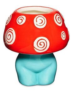 a red and blue mushroom shaped lamp with swirly circles on it's top