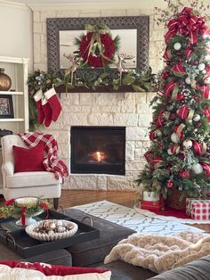 a living room decorated for christmas with red and white decorations