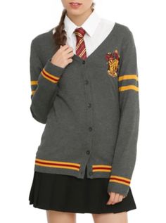 a woman wearing a harry potter sweater and skirt with her hair in a pony tail