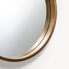 a round mirror hanging on the wall