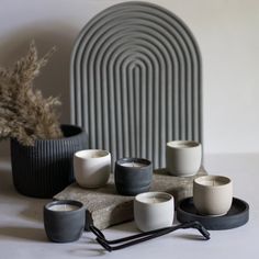 some white and black candles are sitting on a table