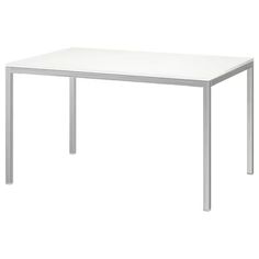 a white table sitting on top of a white floor