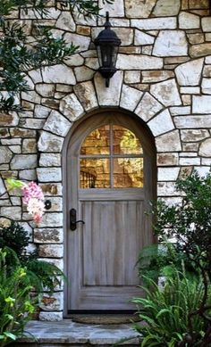 a stone building with a wooden door and window