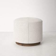 a white stool sitting on top of a cement floor