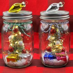 two glass jars with christmas decorations in them