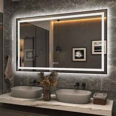 a bathroom with two sinks and a large mirror above it's counter top area