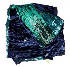 a blue and green blanket laying on top of each other