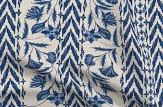 a blue and white fabric with an abstract design on the front, featuring large leaves