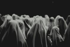 black and white photograph of people dressed in veils