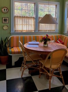 a kitchen table with four chairs and a bench