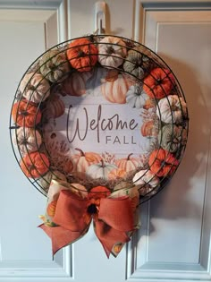 a welcome fall wreath hanging on the front door