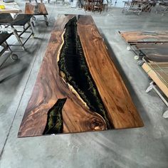 Indulge in opulence with our Black Resin Walnut Epoxy Table. Impeccably crafted, the deep hues of walnut seamlessly intertwine with the luxurious black resin rivers, creating a masterpiece that exudes sophistication. Elevate your space with this statement piece, where the allure of rich wood meets the modern elegance of resin, bringing a touch of lavishness to your surroundings. We offer seven wood types for you to choose from: Black Walnut, Zebrawood, Cunninghamia, Walnut Wood, Poplar Wood, Ash Black Walnut Epoxy Resin Table, Black Walnut Epoxy Table, Black Walnut Countertop, Epoxy Bar Top, Wood And Epoxy Table, Live Edge Epoxy Table, Live Edge Bar Top, Walnut Countertop, Ny House