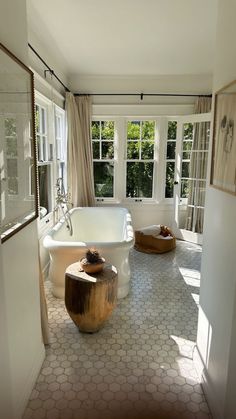 a large white bath tub sitting inside of a bathroom