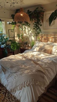 a large bed sitting in a bedroom next to a potted plant on top of a rug