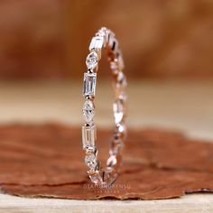 a diamond ring sitting on top of a wooden table