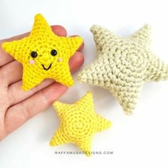 two crocheted stars are being held by someone's hand